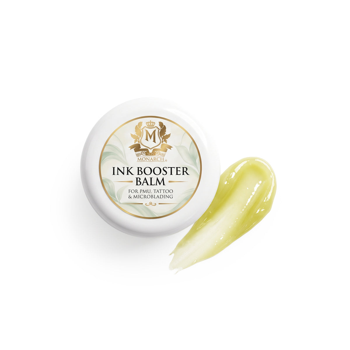 Skin Monarch Ink Booster Balm 30ml, Deckel neben einem glänzenden gelben Balsamstrich