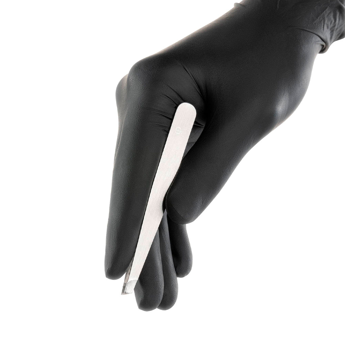 PhiBrows Stainless Steel Scissors & Tweezers — eyebrow tweezers held in a gloved hand