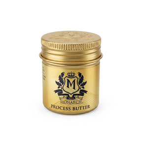 A small cylindrical gold jar of Skin Monarch Process Butter